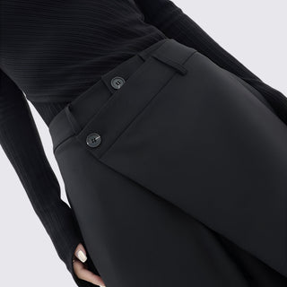 Close-up of a person wearing a black suit with a white background