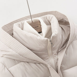 Beige puffer jacket on a hanger with a visible brand tag against a light background
