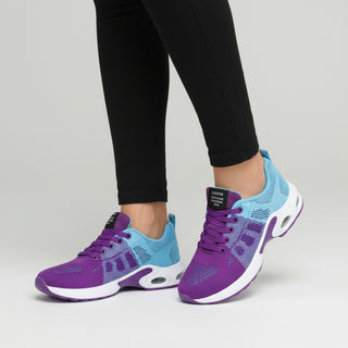 Purple and blue athletic shoes worn with black leggings on a light gray background