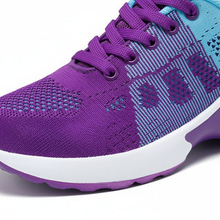 Purple and blue running shoe with white sole on a white background