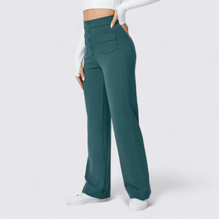 Teal pants worn by a person on a white background