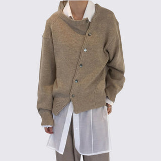 Brown cardigan over a white shirt on a plain background