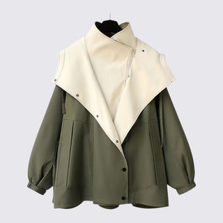 Green and beige jacket on a mannequin against a light gray background