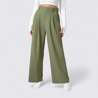 Green wide-leg pants worn by a person on a white background