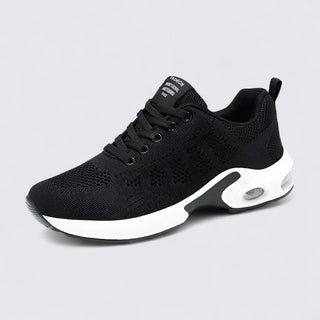 Black athletic shoe with white sole on a light gray background