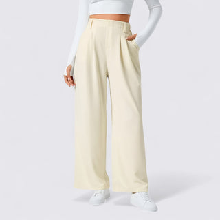 Person wearing light-colored wide-leg pants on a white background