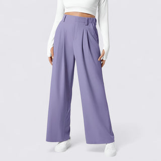 Purple wide-leg pants worn by a person on a white background