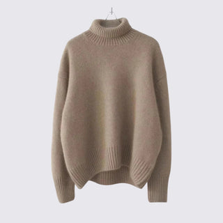 Beige sweater on a hanger against a light gray background