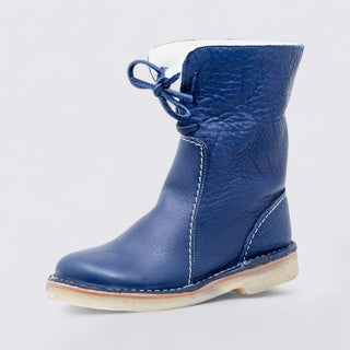 Blue leather boot with a white sole on a light gray background